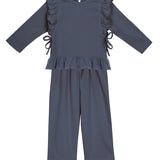 The Robyn Two Piece Set by Mabel and Honey features a navy peplum top with ruffled sides and hem, paired with matching wide-leg pants in a soft cotton blend, shown against a white background.