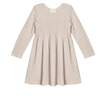 The Millie Natural Waist Dress by Mabel and Honey is a light beige, long-sleeved girl's dress with a smocked bodice and flared skirt, shown laid flat on a white background.