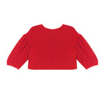 The Holly Jacket by Mabel and Honey is a bright red long-sleeve cropped top with textured fabric and gathered, slightly puffy sleeves, displayed laid flat on a white background.