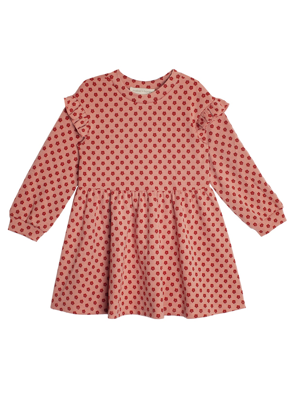 The Red Velvet Dress by Mabel and Honey features long sleeves, ruffled shoulders, a gathered skirt, and playful red polka dots for a charming, feminine look.