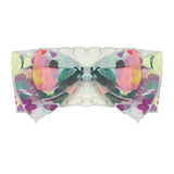 The Watercolor Hair Accessory by Mabel and Honey features a chiffon floral print in pastel pink, green, yellow, purple, and blue on white.