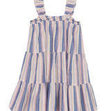 The Riley Rose Dress by Mabel and Honey is a girl's sleeveless, knee-length dress with tiered ruffles and ruffle straps. It features vertical pastel blue, pink, and yellow stripes on white.