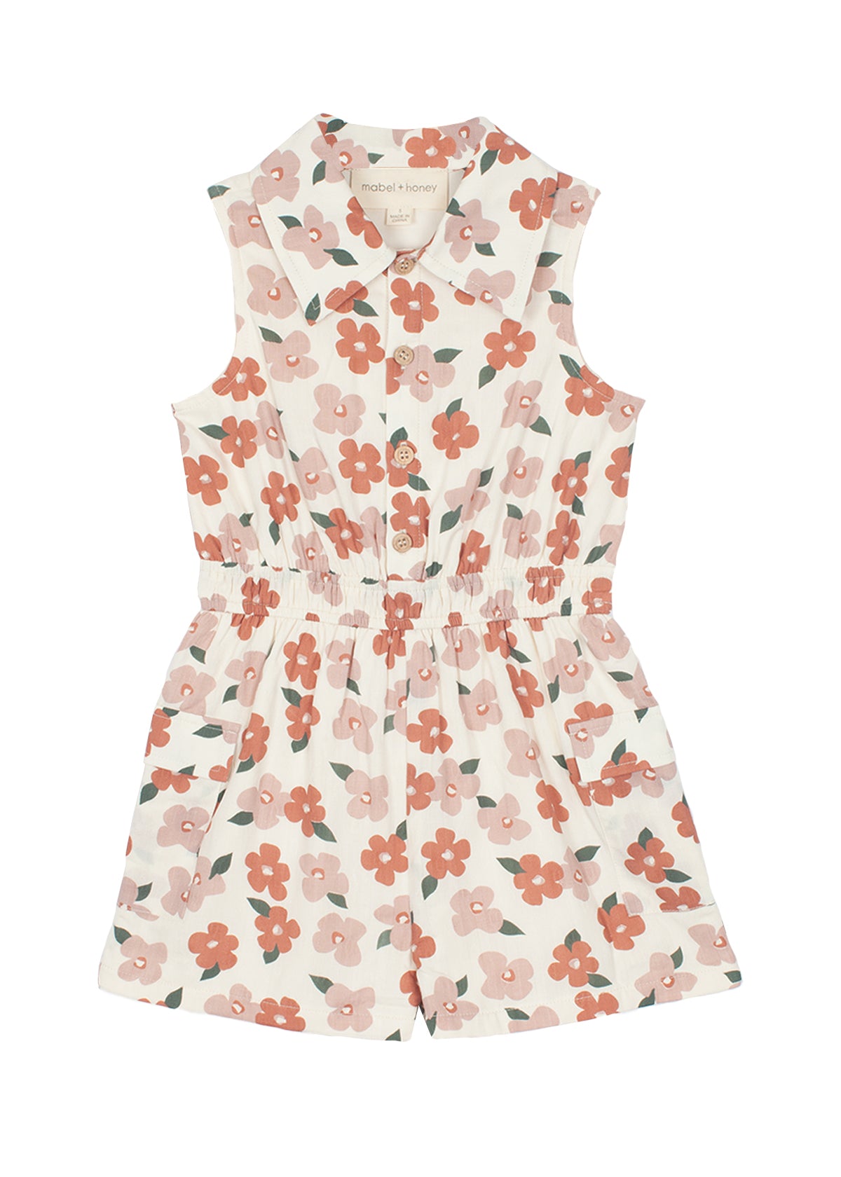 The Mavery Floral Romper by Mabel and Honey is a sleeveless, collared kids’ romper in a pink and red floral print with an elastic waistband and front buttons—perfect for sunny days.