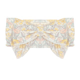 The Mila Floral Hair Accessory by Mabel and Honey features a pastel floral pattern in yellow, pink, and green on a white background.