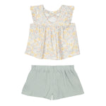 The Mila Two Piece Set by Mabel and Honey features a pastel-printed sleeveless top with ruffled shoulders and loose sage green shorts, displayed flat on a white background.