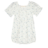 The Bluebell Baby Romper by Mabel and Honey features a white design with blue floral print, gathered neckline, puff sleeves, and a gently ruffled hem for a soft, delicate look.