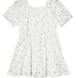 The Bluebells Drop Shoulder Dress by Mabel and Honey is a white, short-sleeved girls’ dress with a gathered bodice, flared skirt, blue floral pattern, and delicate lace trim for added charm.