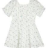The Bluebells Drop Shoulder Dress by Mabel and Honey is a short white girls dress with light blue floral print, drop shoulders, puff sleeves, a gathered square neckline, and fitted waist.