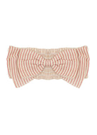 The Cranberry Crush Hair Accessory by Mabel and Honey is a cream-colored girls headband with an oversized bow, detailed with thin red vertical stripes evenly spaced on both the bow and band.