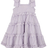 The Mabel and Honey Super Bloom Tiered Dress is a sleeveless, lavender gingham dress with wide straps and ruffled tiers—an adorable addition to any girls wardrobe.