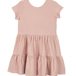 The Mabel and Honey Josie Dress is a blush pink short-sleeve girl's dress with a round neckline, tiered ruffled skirt, and subtle textured fabric, shown laid flat on a white background.