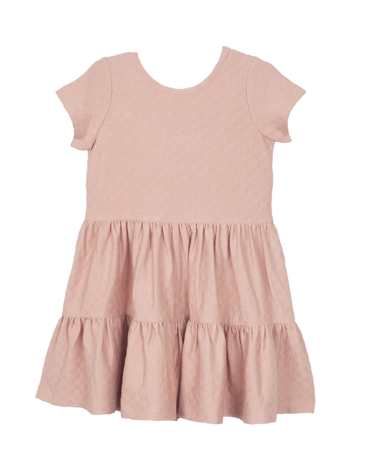 The Mabel and Honey Josie Dress is a blush pink short-sleeve girl's dress with a round neckline, tiered ruffled skirt, and subtle textured fabric, shown laid flat on a white background.