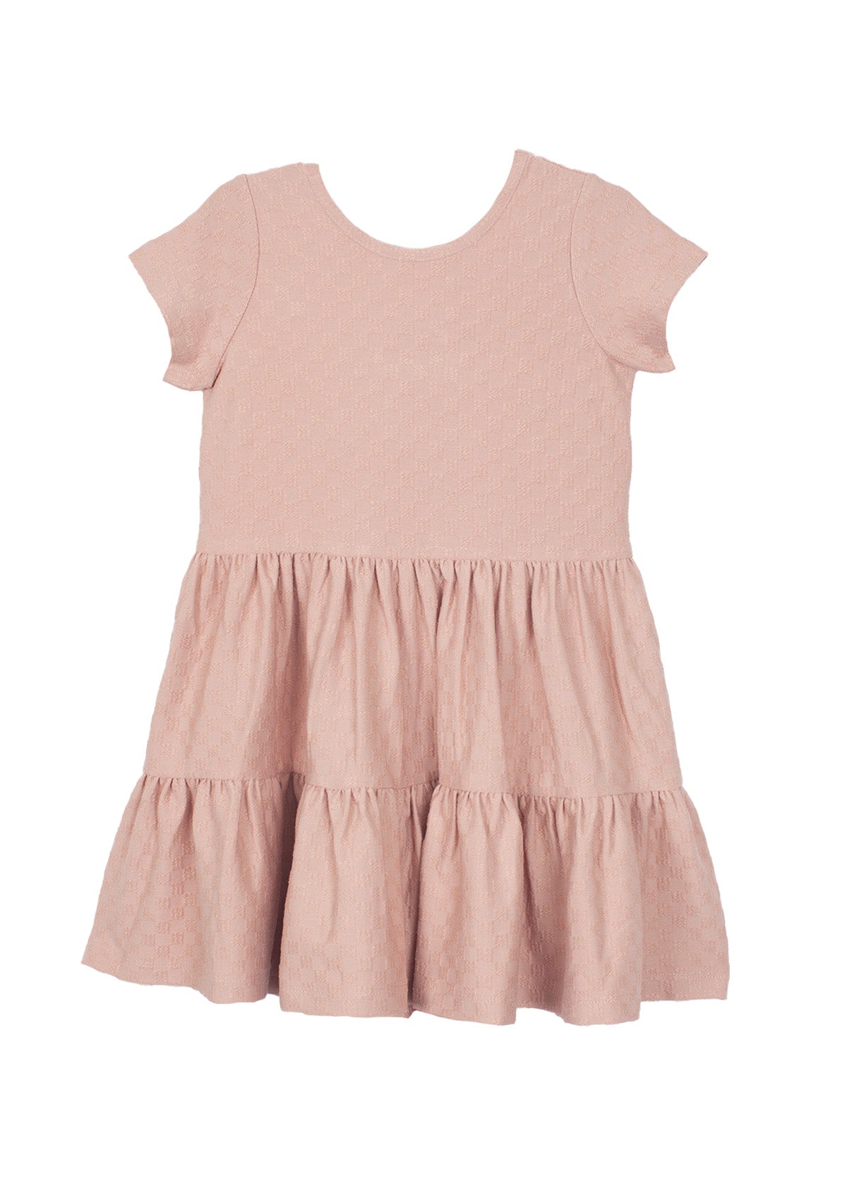 The Mabel and Honey Josie Dress is a blush pink short-sleeve girl's dress with a round neckline, tiered ruffled skirt, and subtle textured fabric, shown laid flat on a white background.
