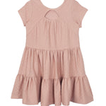 The Josie Dress by Mabel and Honey is a blush pink, short-sleeved girl's dress in soft terry cloth with a round neckline, teardrop cutout, and tiered ruffle skirt. Shown flat on a white background.