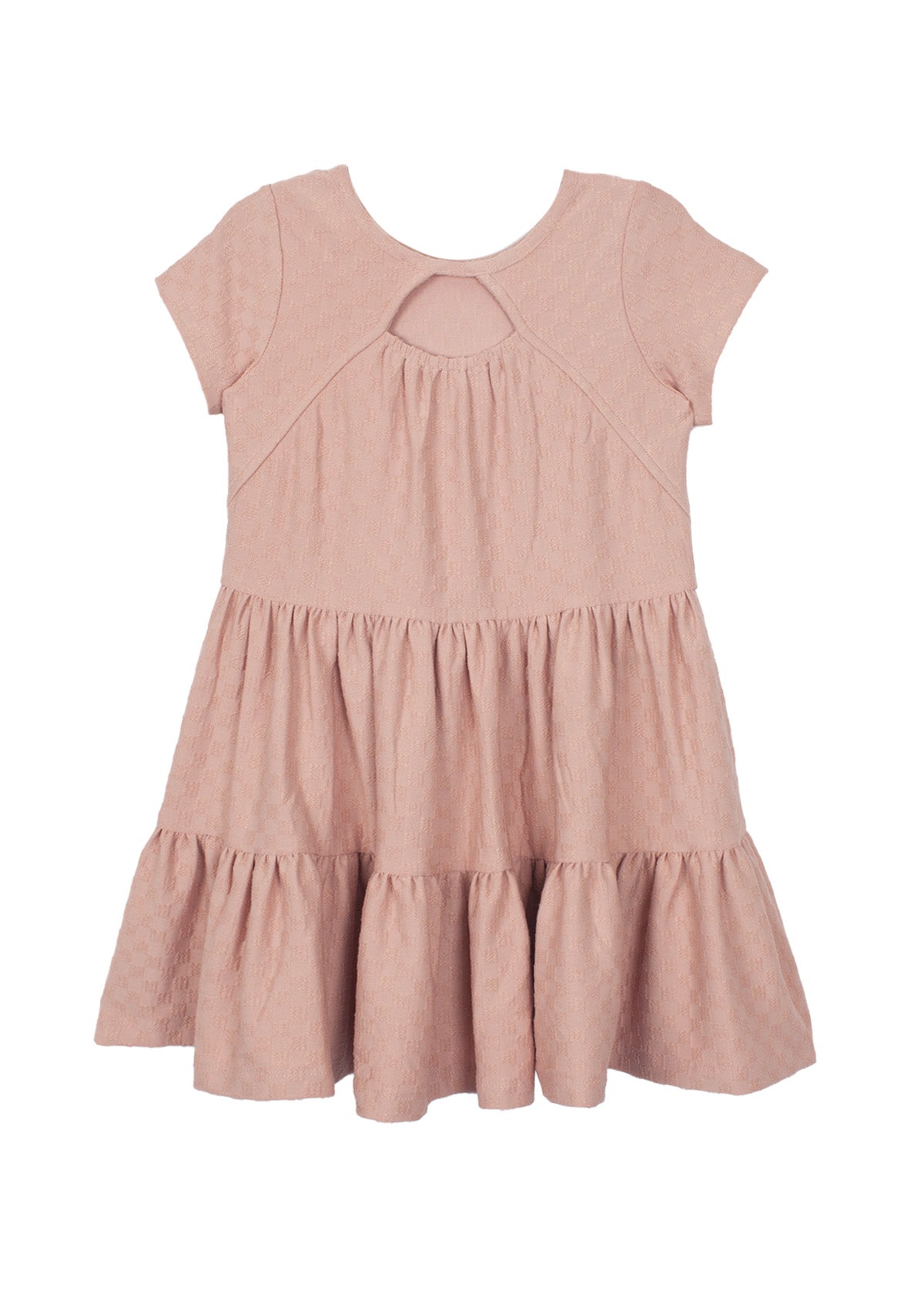 The Josie Dress by Mabel and Honey is a blush pink, short-sleeved girl's dress in soft terry cloth with a round neckline, teardrop cutout, and tiered ruffle skirt. Shown flat on a white background.