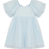 The Ella Dress by Isobella and Chloe is a pastel blue girls dress with a flared skirt, textured polka dot semi-sheer fabric, and flutter sleeves. Its short sleeves and loose fit ensure cool, comfortable wear.