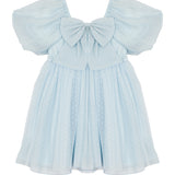 The Ella Dress by Isobella and Chloe is a pastel blue girls' dress with butterfly sleeves, a large chest bow, and a flared skirt with a subtle dotted pattern.