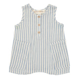 The Blake Baby Romper by Beckett and Bear is a sleeveless children’s romper made from 100% cotton with light blue and white stripes, wooden front buttons, and two large front pockets.