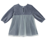 The Skylar Blue Suede Dress by Mabel and Honey features long sleeves, a round neckline, back button closure, and a sheer layered tulle skirt for an elegant touch.