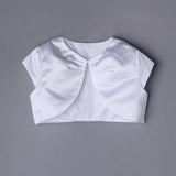 The Mabel and Honey Communion Satin Bolero features white satin, short sleeves, a rounded front opening, and gentle neckline gathering—ideal for communions or special occasions—shown on a plain gray background.