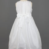 The Mabel and Honey Taffeta Bow Communion Dress features a sleeveless white design, full taffeta skirt, large back bow, and a beaded pearl neckline, displayed on a dress form against a gray background.