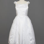 The Mabel and Honey Chiffon Ruffle and Satin Flower Girl Dress features hand-beaded embellishments, ruffle cap sleeves, and a layered skirt, shown on a mannequin against a gray background.