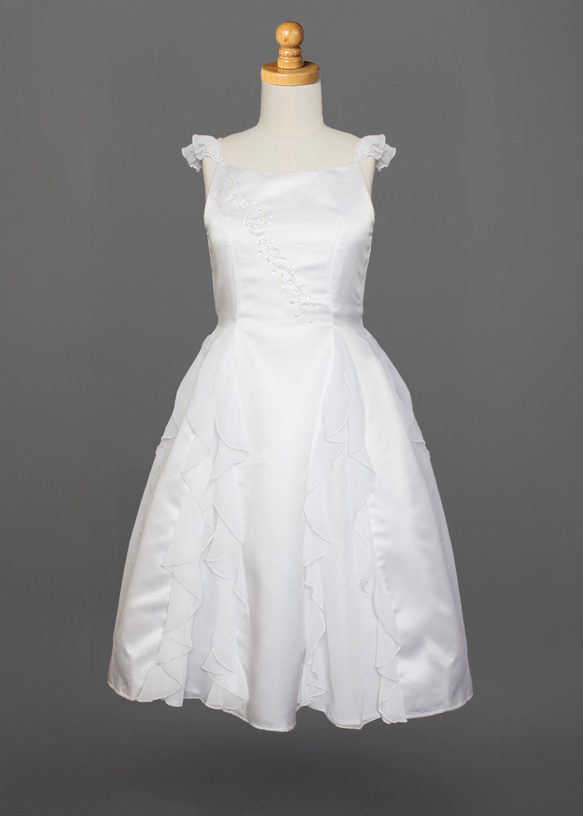 The Mabel and Honey Chiffon Ruffle and Satin Flower Girl Dress features hand-beaded embellishments, ruffle cap sleeves, and a layered skirt, shown on a mannequin against a gray background.