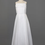 The Mabel and Honey Satin A-Line Communion Dress features hand beaded embellishments, a sleeveless design, and thin straps, shown on a mannequin against a plain gray background.
