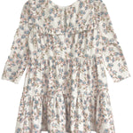 The Sadie Dress by Mabel and Honey is a charming white baby girl dress with long sleeves, a ruffled yoke, tiered skirt, and soft blue and pink floral pattern—ideal for any occasion.