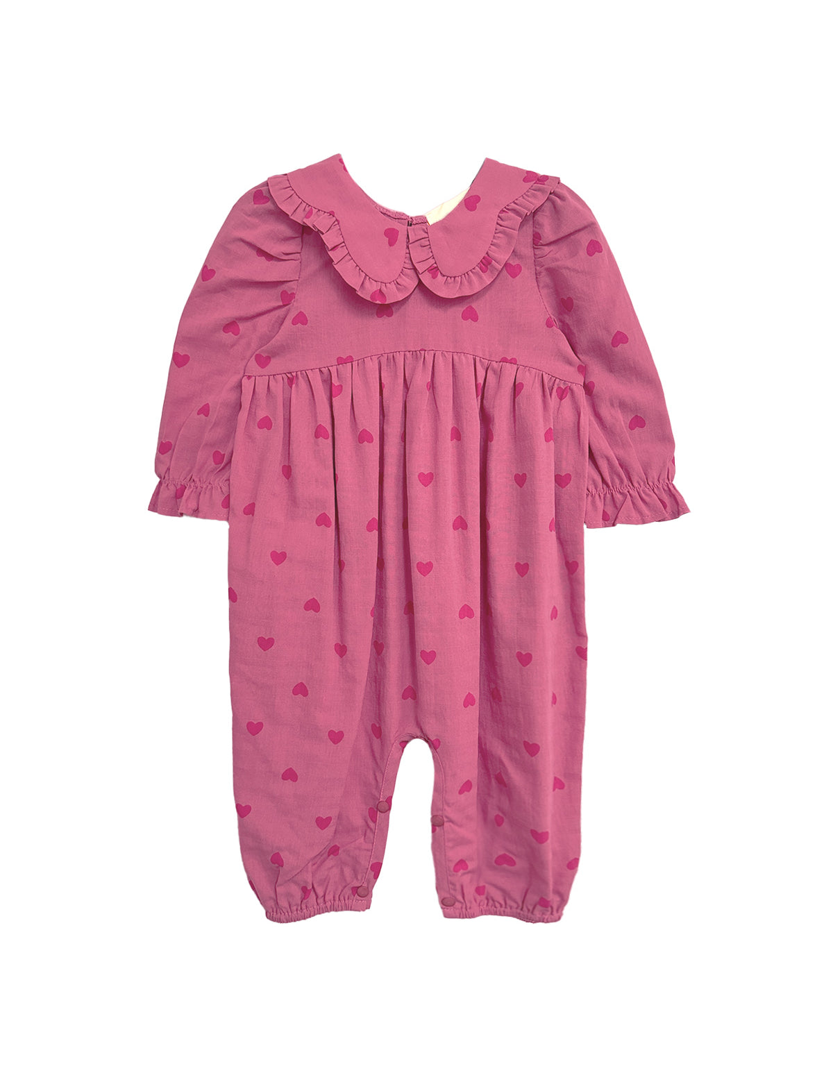 The Perfect in Pink Romper by Mabel and Honey is a baby girl romper featuring long sleeves, a ruffled collar, elasticized cuffs and ankles, and a cute dark pink heart pattern for a sweet, playful look.