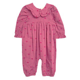 The Perfect in Pink Romper by Mabel and Honey is a baby girl romper featuring long sleeves, a ruffled collar, elasticized cuffs and ankles, and a cute dark pink heart pattern for a sweet, playful look.