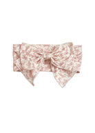 The Primrose Hair Accessory by Mabel and Honey features a wide, light pink fabric with a delicate floral print and a large, structured pink botanical bow at the front.