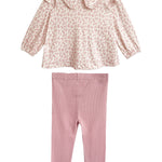 The Mabel and Honey Primrose Two Piece Set features a charming pink floral long-sleeved top with a large collar and plain light pink leggings—a perfect outfit for any baby girl.