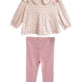 The Mabel and Honey Primrose Two Piece Set features a charming pink floral long-sleeved top with a large collar and plain light pink leggings—a perfect outfit for any baby girl.