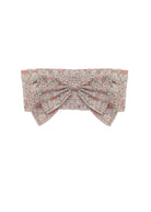 The Emmaline Hair Accessory by Mabel and Honey is a vintage-inspired headband with a soft pink and gray floral pattern, oversized bow, and crisp white background.