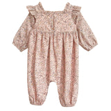 The Mabel and Honey Paisely Romper features long sleeves, a pink and beige floral paisley print, ruffled shoulders, gathered cuffs at wrists and ankles, and a square neckline—perfect for your stylish little one.