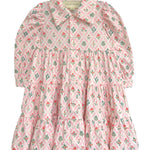 The Dixie Pink Floral Dress by Mabel and Honey is a long-sleeved dress with a tiered silhouette, pink floral pattern, a collar, and front buttons, shown flat on a white background.