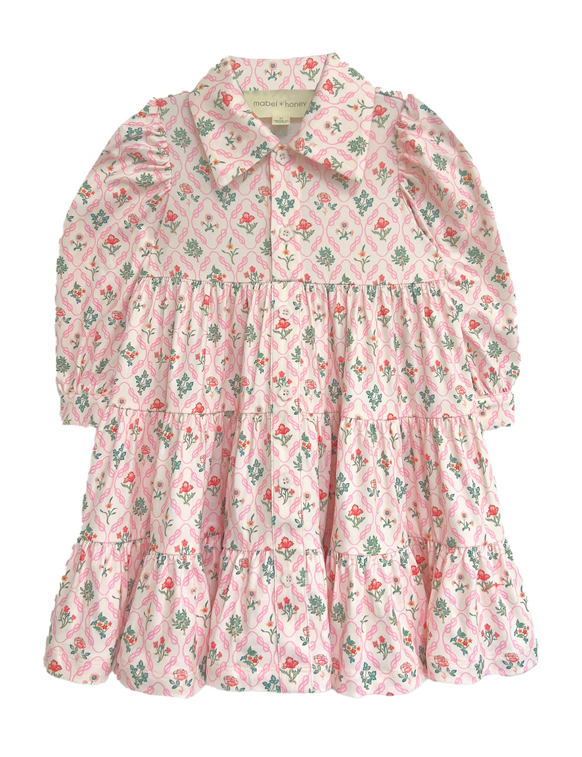 The Dixie Pink Floral Dress by Mabel and Honey is a long-sleeved dress with a tiered silhouette, pink floral pattern, a collar, and front buttons, shown flat on a white background.