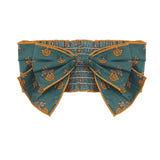 A teal belt with yellow floral patterns, an oversized center bow, and gold-trimmed edges pairs perfectly with the Mabel and Honey Autumn Ivy Hair Accessory.