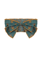 A teal belt with yellow floral patterns, an oversized center bow, and gold-trimmed edges pairs perfectly with the Mabel and Honey Autumn Ivy Hair Accessory.