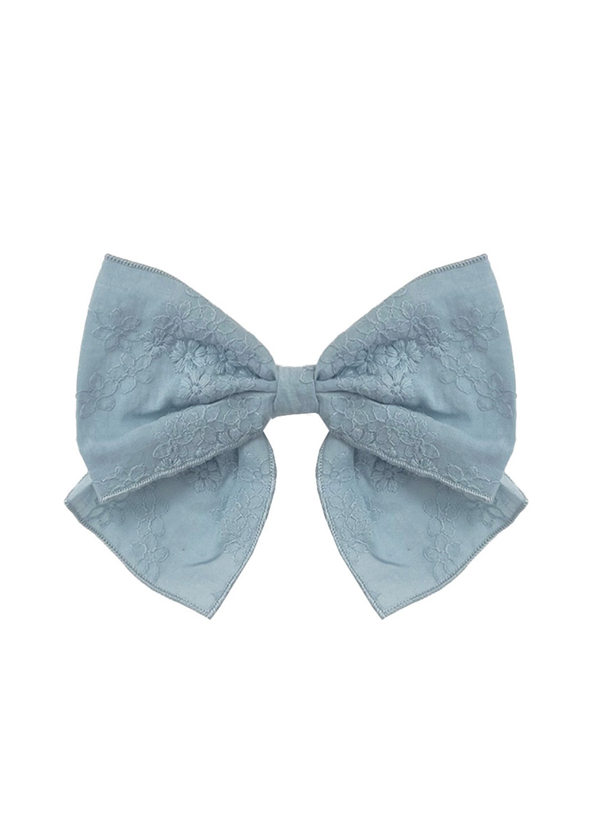 The Mabel and Honey Eva Hair Accessory is a large, light blue bow with a subtle floral pattern and gently curved ribbon tails, shown on a white background.