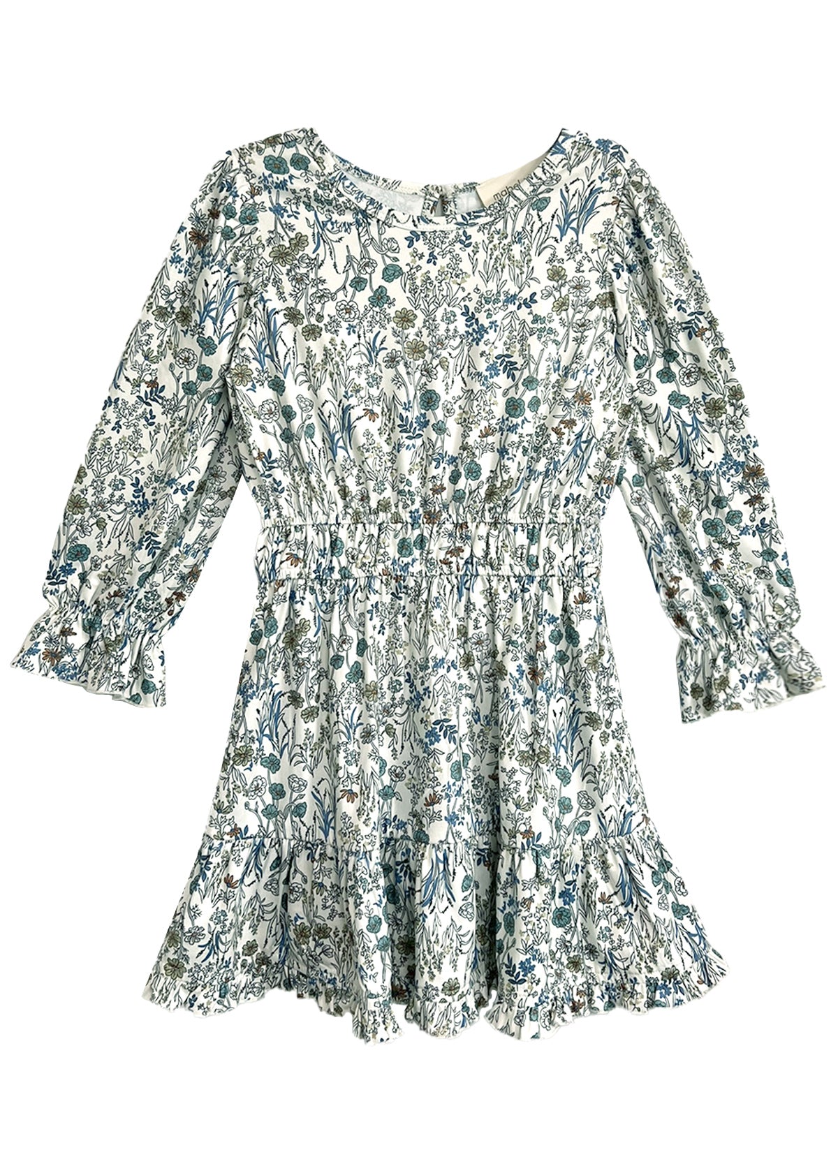 The Brooklyn Floral Dress by Mabel and Honey is a long-sleeve white dress with a green and blue floral pattern, cinched waist, ruffled cuffs, and ruffled hem.