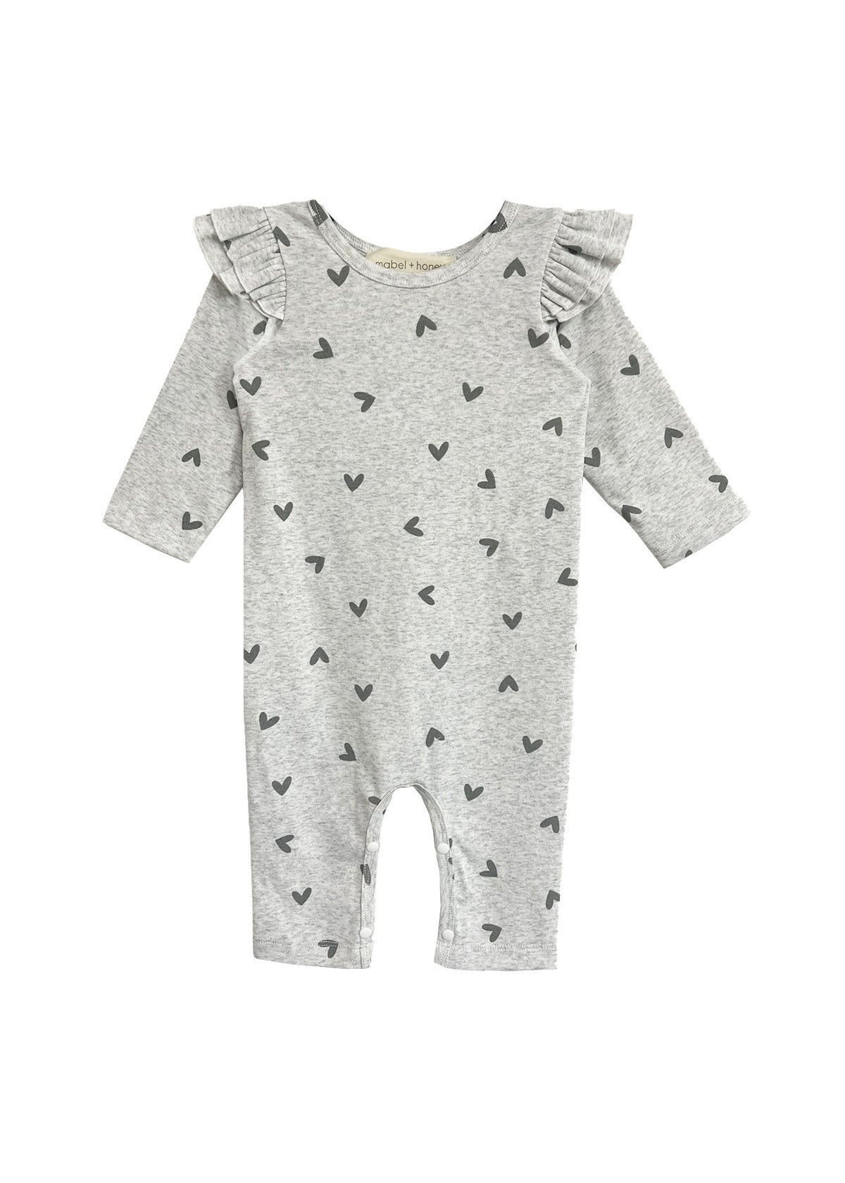 The Heartfelt Romper by Mabel and Honey features ruffled shoulders and tiny black hearts on gray fabric, making an adorable baby outfit. Shown against a white backdrop.