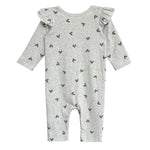 The Heartfelt Romper by Mabel and Honey is a long-sleeved, light gray romper with black heart patterns and ruffled shoulders, shown laid flat on a white background.