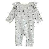 The Heartfelt Romper by Mabel and Honey is a long-sleeved, light gray romper with black heart patterns and ruffled shoulders, shown laid flat on a white background.