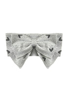 The Mabel and Honey Heartfelt Hair Accessory is a gray baby headband with a bow and black heart print, shown on a white background.