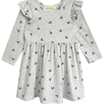 The Heartfelt Dress by Mabel and Honey features a gray base with black heart prints, ruffled shoulders, and a gathered waist—blending comfort and adorable style for your toddler.