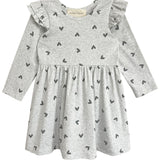 The Heartfelt Dress by Mabel and Honey features a gray base with black heart prints, ruffled shoulders, and a gathered waist—blending comfort and adorable style for your toddler.