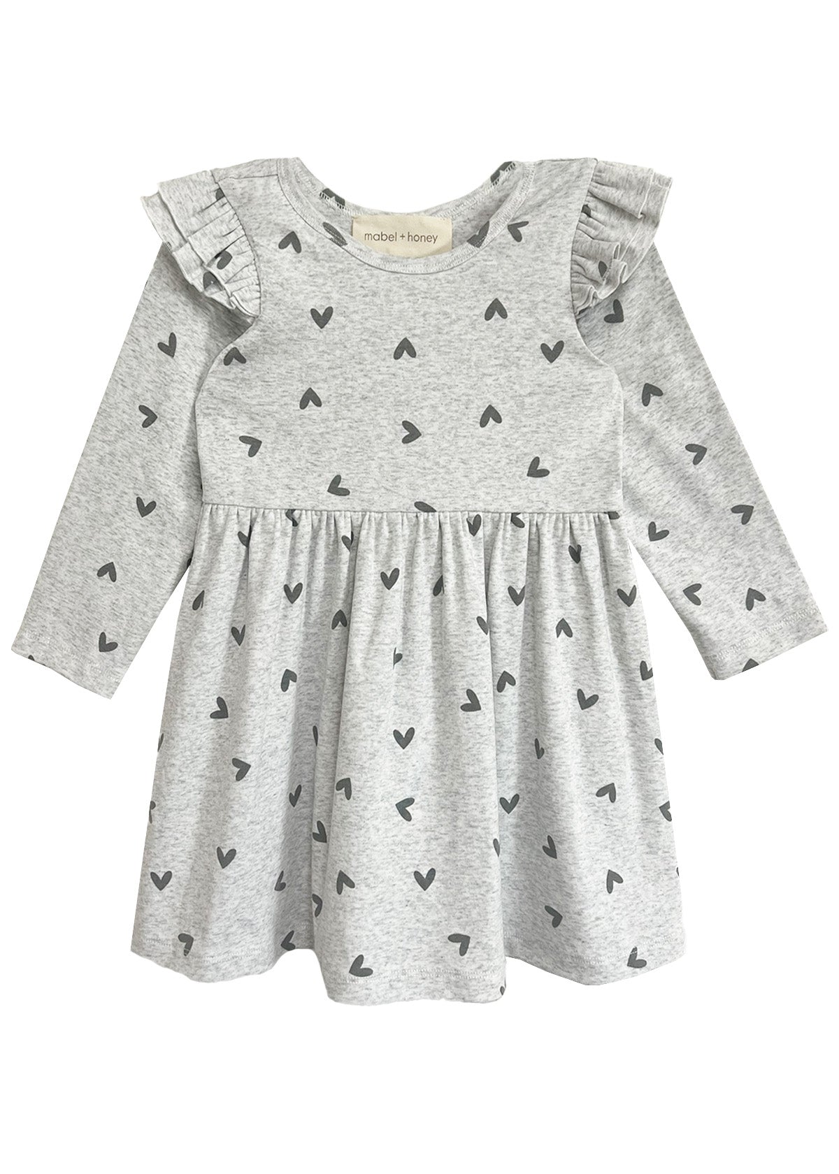 The Heartfelt Dress by Mabel and Honey features a gray base with black heart prints, ruffled shoulders, and a gathered waist—blending comfort and adorable style for your toddler.