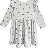 The Mabel and Honey Heartfelt Dress is a light gray, long-sleeved dress with small black hearts, ruffled shoulders, a gathered waist, and a casual design—perfect for everyday wear.